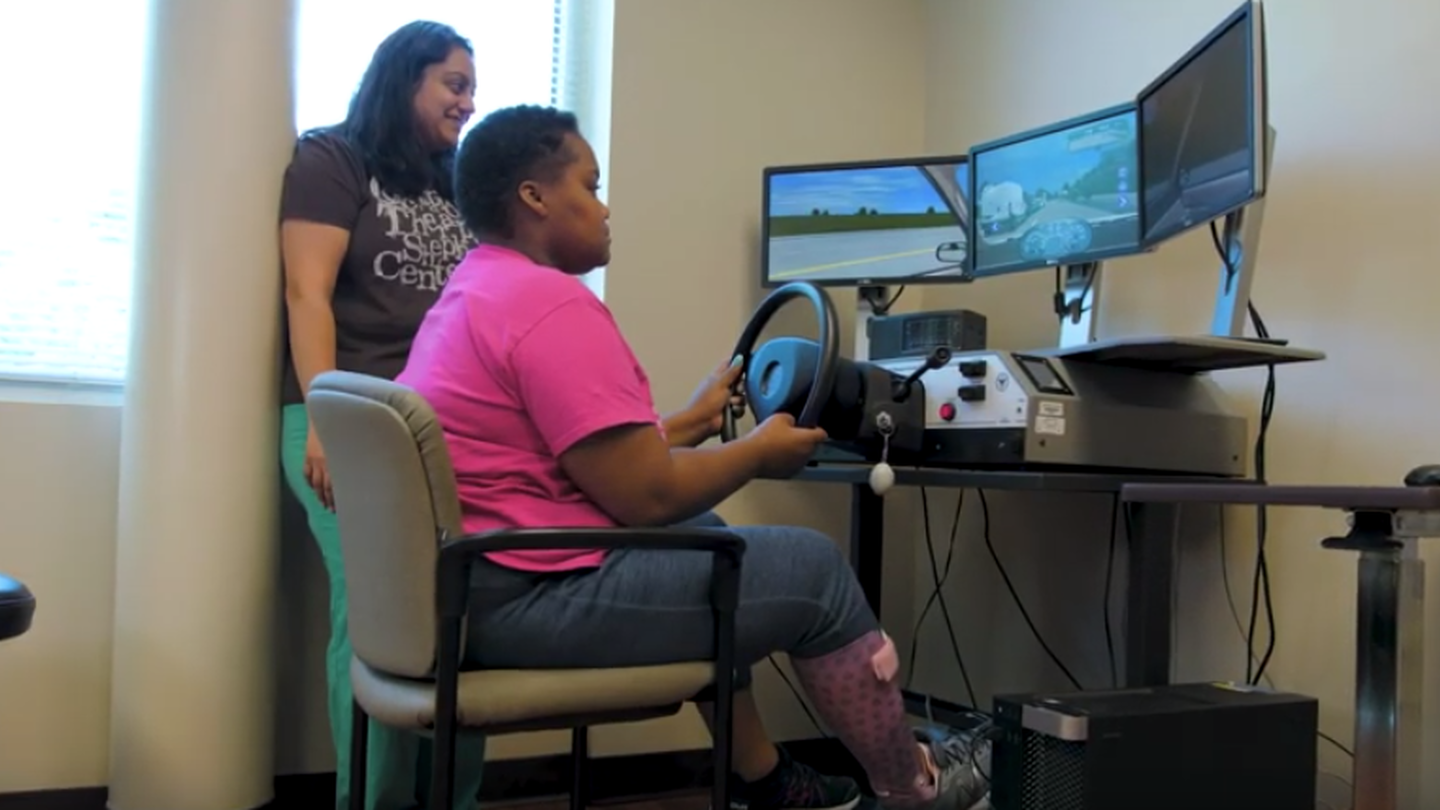 A research participant at Shepherd Center useing a computer simulated driving technology